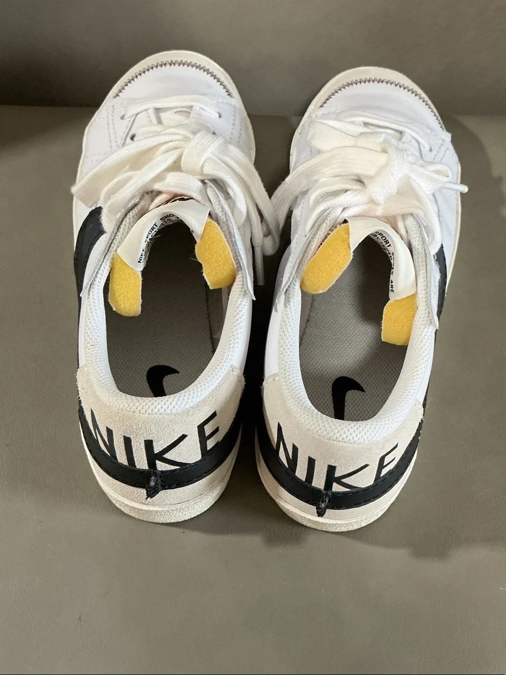 Nike White Low-Top Sneakers with Black Swoosh and Neon Yellow Accents